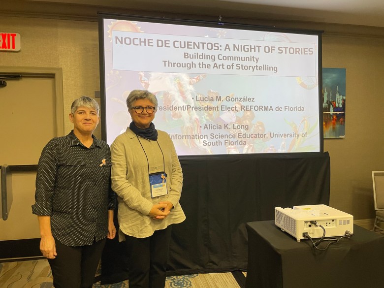 Alicia and Lucia Gonzalez stand in front of presentation screen